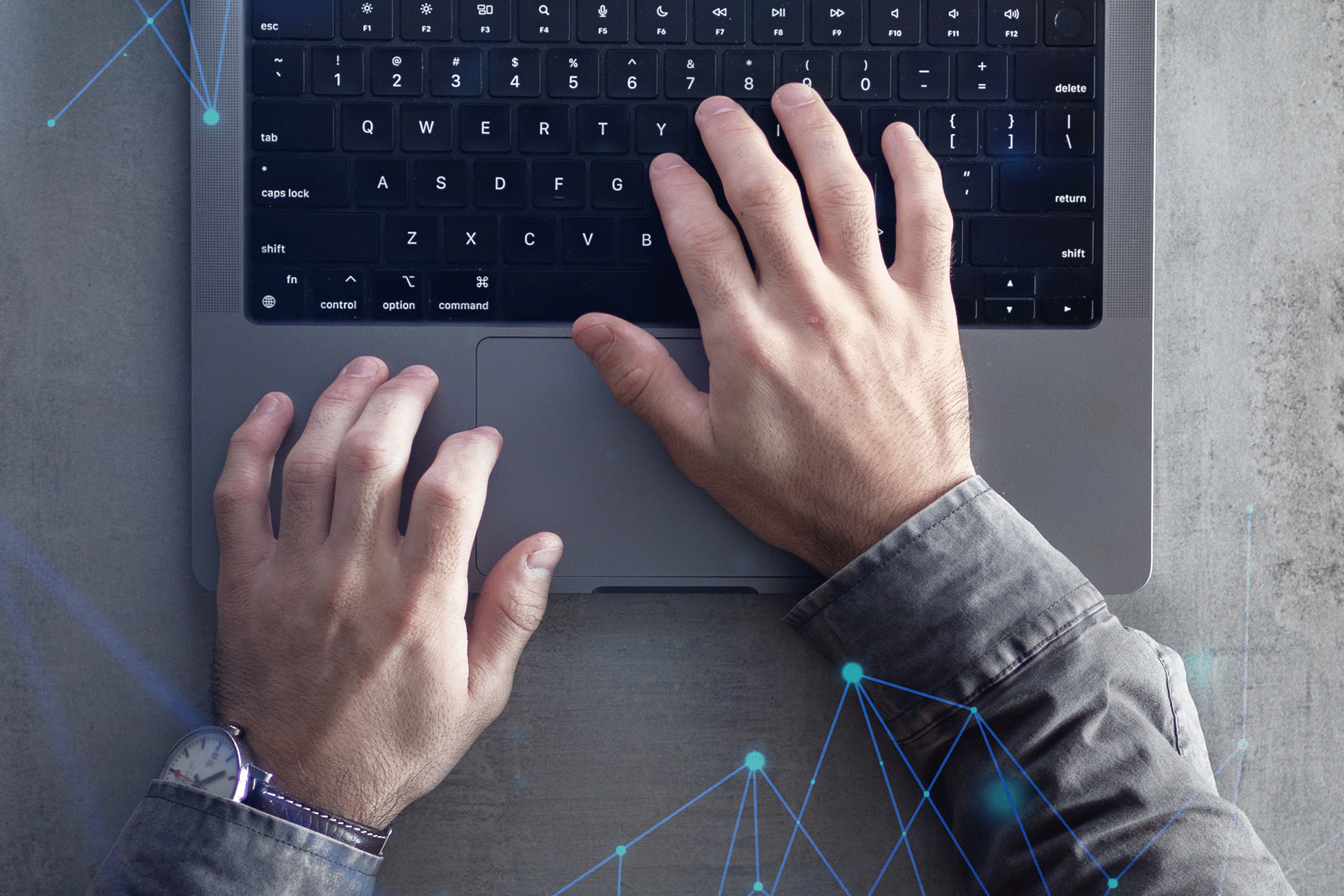 A business person's hands typing on a laptop with blue digital data icons overlaid.
