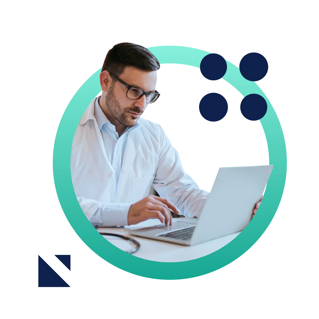 A male doctor in a white coat working at his desk on a laptop. The image is placed inside a graphic green circle.