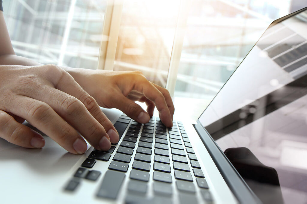 Fingers on laptop keys